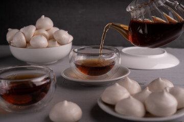 teapot, tea, teacup, plate, meringue, cookie, setting, dark, transparent, partially, filled, cozy, ambiance, suitable, enjoying, sweets, small, white, light, table, texture