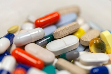 Colorful pills and tablets on white background
