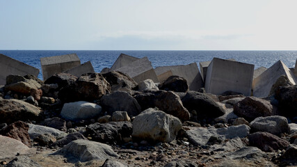 Breakwater with concrete blocks and stones for protection from strong ocean waves
