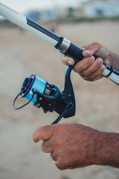 Experienced fisherman handles fishing rod on Valencia beach