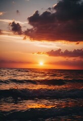 Obraz premium The warm glow of the setting sun casts golden hues over the tranquil waves of the ocean, creating a serene atmosphere by the shoreline during dusk. Sunset or sunrise at sea. Romantic landscape. AI