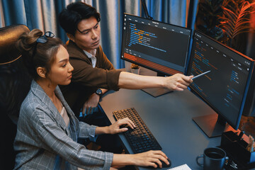 IT developers discussing with point to intelligent website development coder system running data...