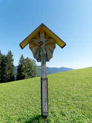 Wooden cross on a hiking trail in Bavaria.