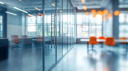 Fototapeta premium Beautiful blurred background of a modern office interior in gray tones with panoramic windows, glass partitions, and orange color accents. 