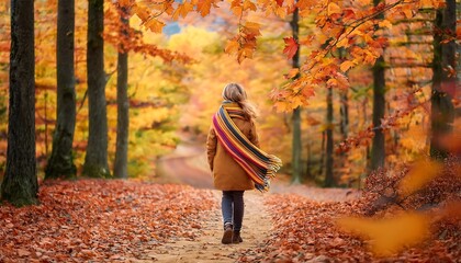 A girl hiking through a colorful autumn woodland trail with vibrant leaves and a cozy scarf. Generative AI