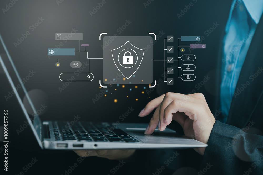 Poster close-up of a person working on a laptop with digital security interface on screen, emphasizing cybe