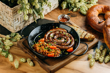 Grilled sausage coil with braised cabbage and dipping sauce, served with toasted bread