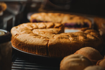 Chicken pie front view close up. Display case with a variety of cakes and cupcakes. Deserts at...