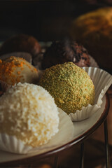 Delicious variety of cakes and pastries at cafe. Dessert in the form of round balls of different...