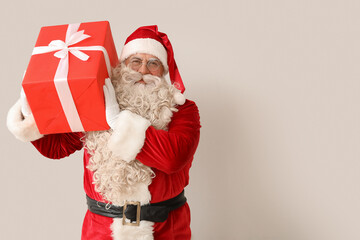 Santa Claus with Christmas gift on white background