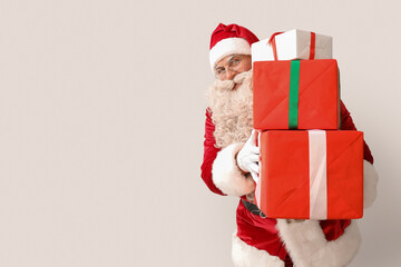 Santa Claus with Christmas gifts on white background