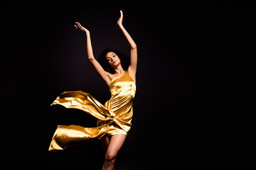 Photo of carefree adorable lady dressed gold outfit enjoying ballet dance isolated black color...
