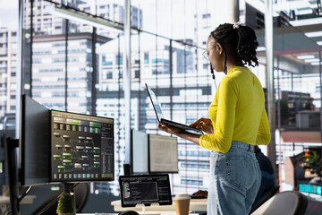 Engineer using laptop device, working with machine learning tech advancing AI critical to innovation of autonomous systems. Woman transforming data into predictive models using notebook