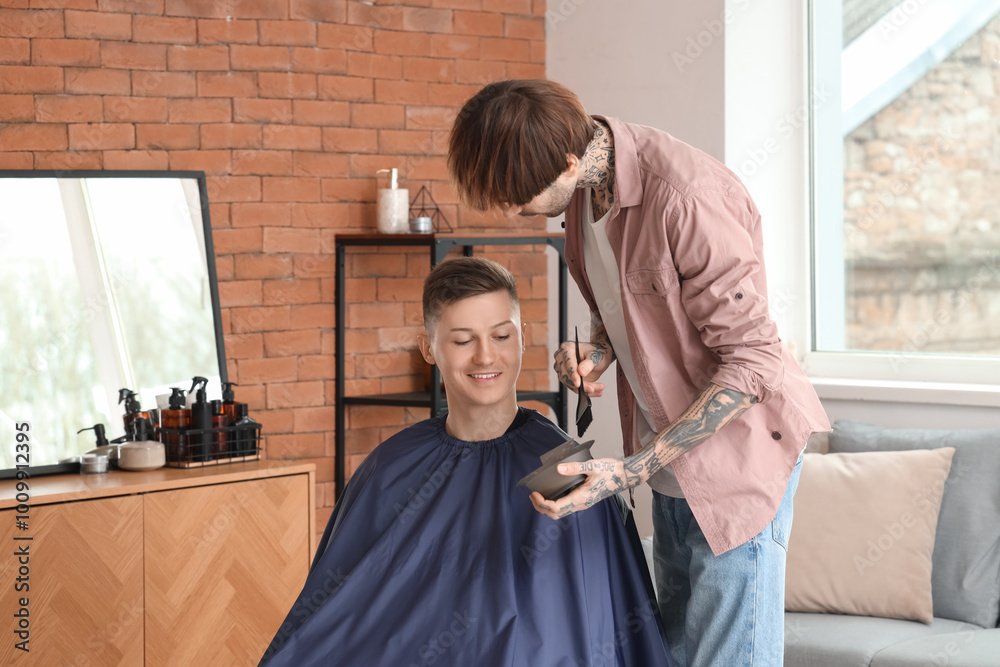 Sticker Male hairdresser dyeing client's hair in barbershop