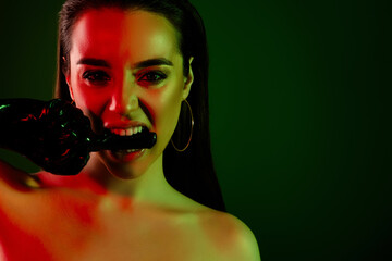 Close up cropped portrait of passionate model woman bite finger latex gloves empty space neon light...