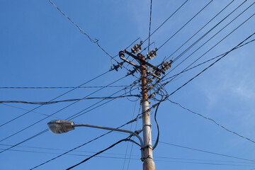Electrical substations and street lighting.Electrical substation with lots of cables. Street lighting attached to an electricity substation