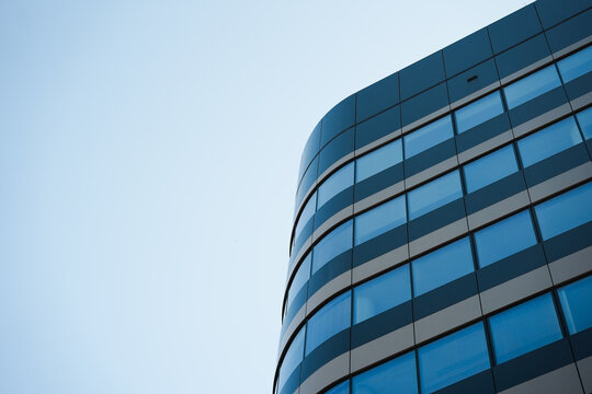 Fototapeta New building architecture on blue sky background,Low angle architectural exterior view of modern,copy space for text