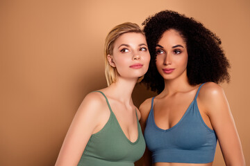 Photo of attractive dreamy ladies dressed underwear top cuddling looking empty space isolated beige color background