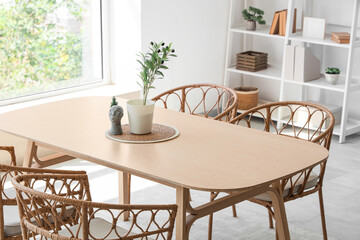 Plants with decor on dining table in room