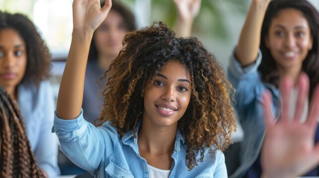 Businesswoman engaging in a presentation, seeking input and answering questions from the audience during a seminar. Female team member raising hand during training or strategy session