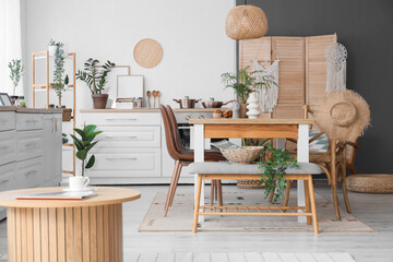 Bench, table and chairs in interior of stylish dining room