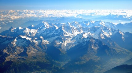 Obraz premium Aerial View of Snow-Capped Mountains with a Valley Below