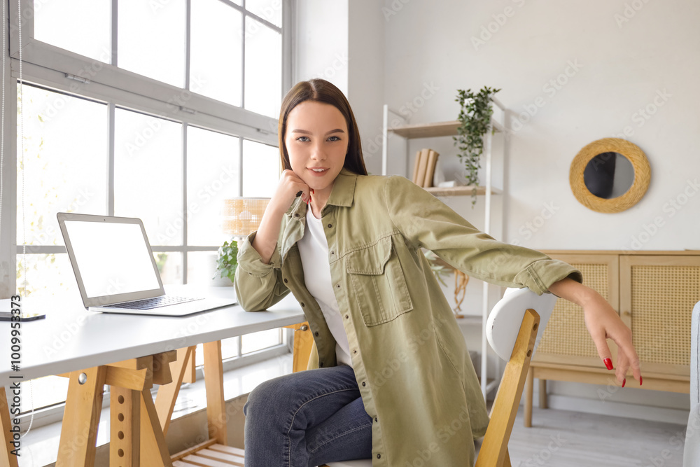 Canvas Prints Young woman with laptop on table at home