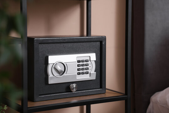 Modern safe on shelf in bedroom, closeup