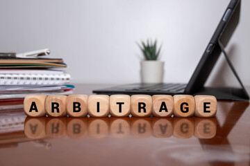 ARBITRAGE word made with building blocks.