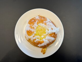Skolebolle, Stortorget, Tromsø, Norway - nostalgic treat skolebrød served on a white plate at small caffe shop in town as a local specialty