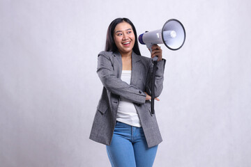 Fototapeta premium beautiful office female screaming cheerful candid hugging holding megaphone loudspeaker wearing grey suit isolated on white background. for fashion, lifestyle, advertising, broadcast, shopping content