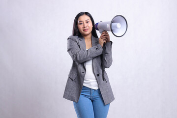 beautiful young woman screaming office relax both hands holding megaphone loudspeaker wearing grey suit isolated on white background. fashion concept, lifestyle, advertising, announcement, discount