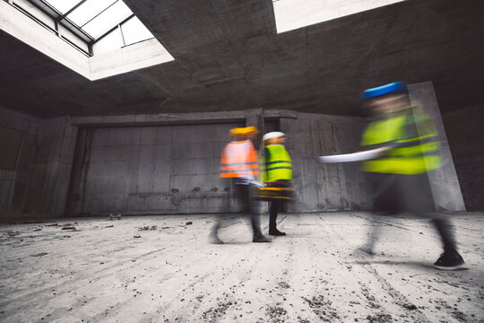 Construction industry and engineering - engineers, architects and contractors on the construction site analyzing the development of the building