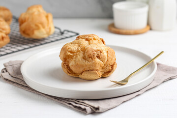 Choux pastry on a white plate. perfect for recipe, article, or any commercial purposes.