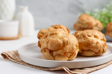 Choux pastry on a white plate. perfect for recipe, article, or any commercial purposes.