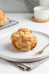 Choux pastry on a white plate. perfect for recipe, article, or any commercial purposes.