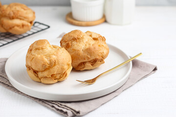 Choux pastry on a white plate. perfect for recipe, article, or any commercial purposes.