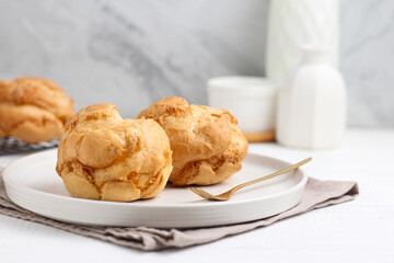 Choux pastry on a white plate. perfect for recipe, article, or any commercial purposes.