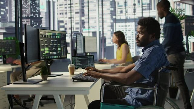 Software technician with disability in inclusive workplace working with machine learning tech. African american IT expert with paraplegia in wheelchair transforms data into predictive models
