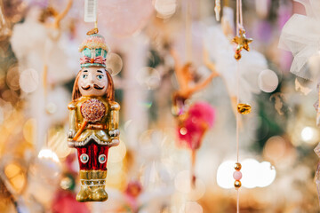 Nutcracker doll.Christmas holiday symbol on a blurred backgroundChristmas toys and decorations.Winter festive beautiful background in gold tones