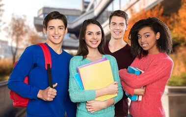 Group of happy young students at campus together