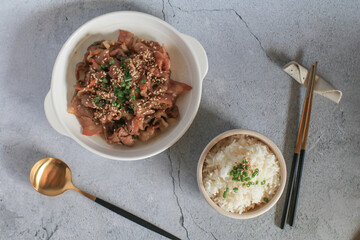 Homemade pork stir fry with onion and japanese sauce eat with rice on table. Delicious dinner or lunch. 