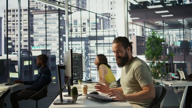 Annoyed programmer at work raging after losing all progress due to computer crash while creating machine learning models. Angry IT worker smashing desk in frustration while programming, camera B