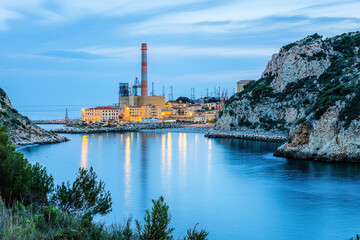 Obraz premium Mediterranean coast with power plant and its coal pier in the town.