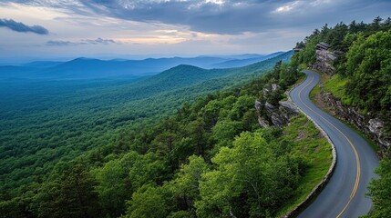 Fototapeta premium Serene Mountain Road Amidst Lush Green Landscape
