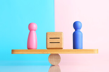 Gender equality concept. Cube with equals sign between male and female figures on scales against...