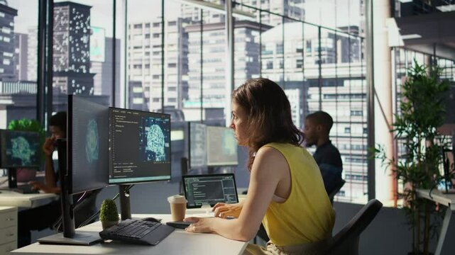 Hacker in office using laptop to steal company secrets, doing data breach, hiding from manager. Employee hired by competitor to spy, mining info from servers, closing notebook lid to hide, camera B