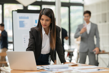 Group of Asian businessmen are giving a presentation in the company.