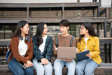 Group of students reading books and doing homework in the university area