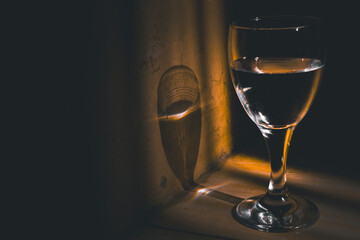 glass of champagne, a glass of water in low light